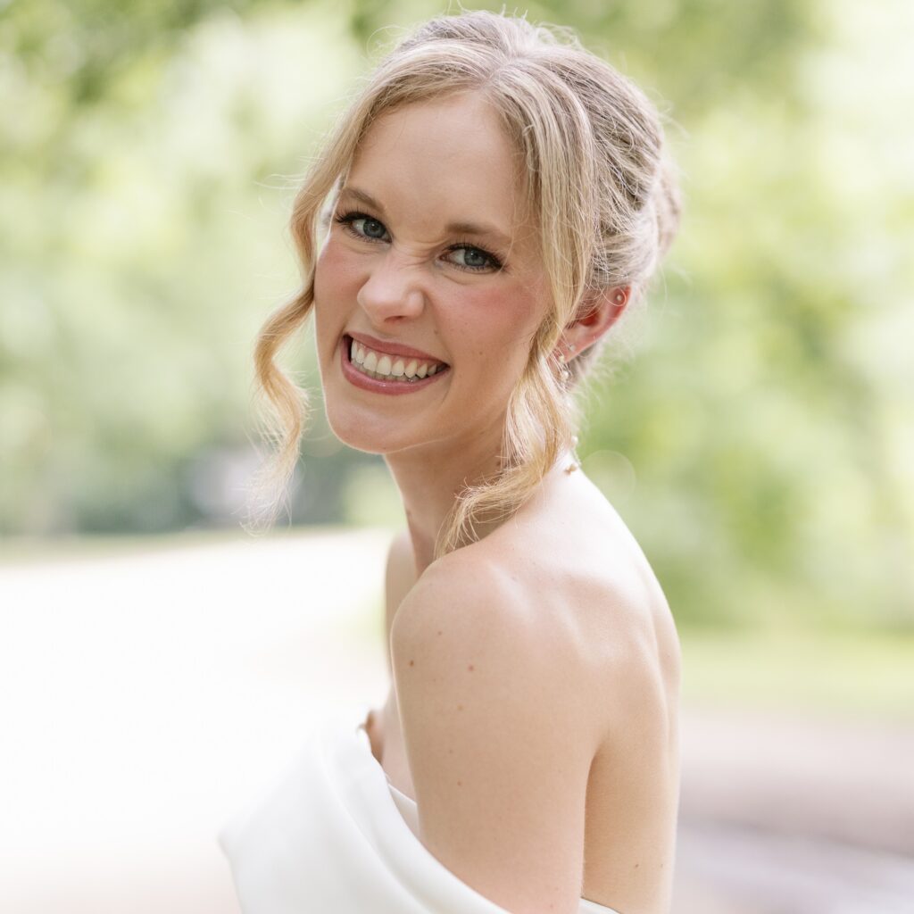 Elise Werchan, wedding planner, smiling outdoors in a bridal portrait