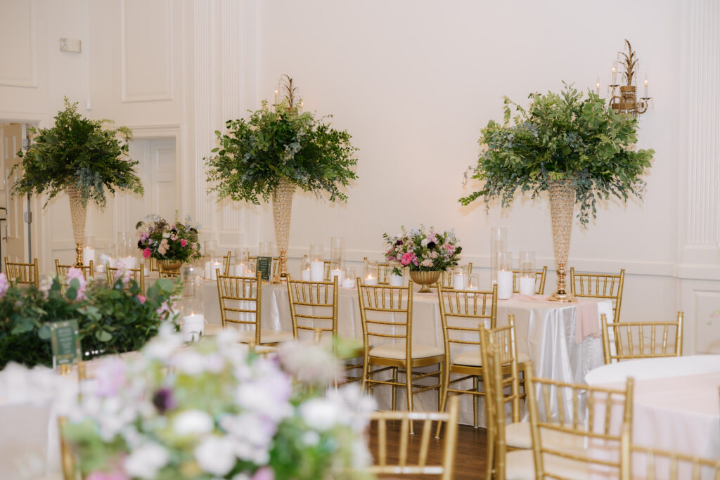 Wedding reception with large greenery centerpieces at Arlington Hall in Dallas