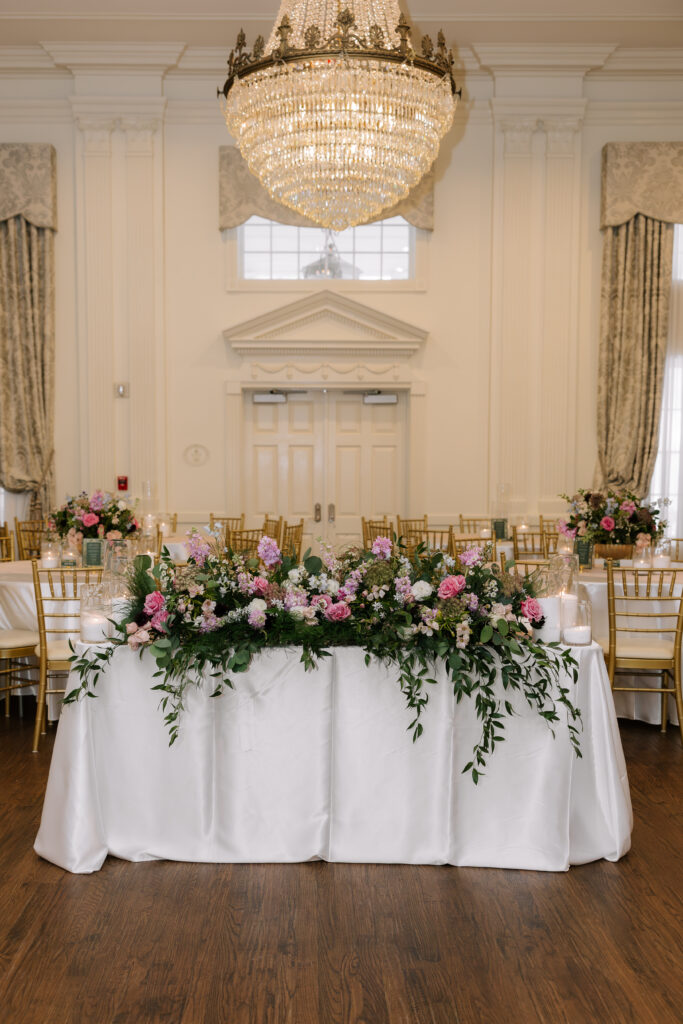 Wedding reception with floral arrangement covering table at Arlington Hall in Dallas