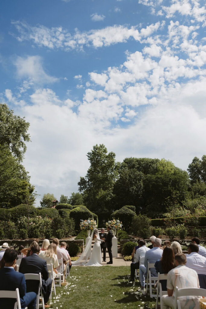 Bride and groom having a wedding ceremony at Dallas Arboretum