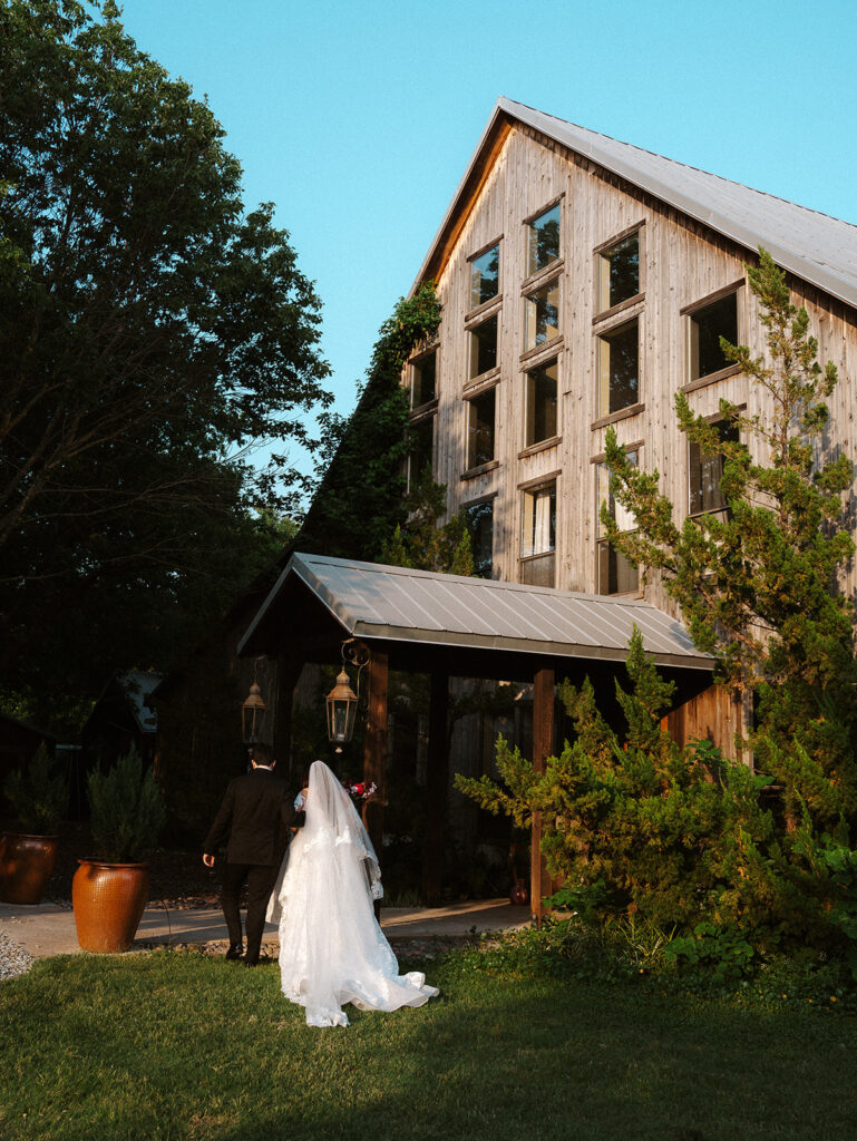 Bride and groom in front of house at Avalon Legacy Ranch