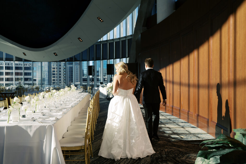 Bride and groom walking around wedding reception at the Dallas Petroleum Club