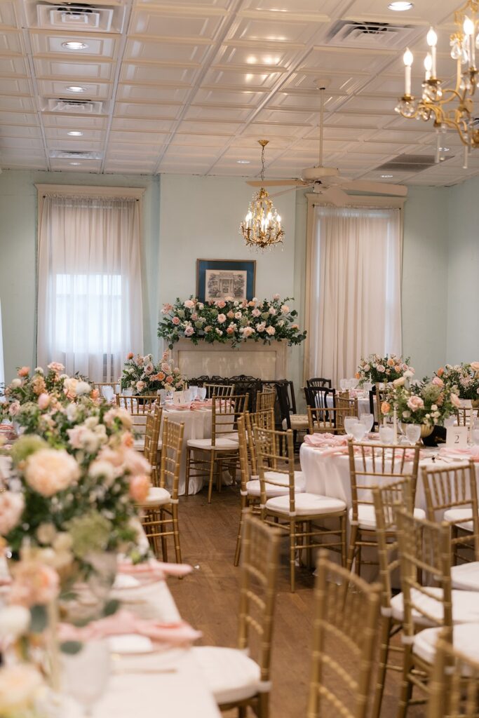 Wedding venue in Dallas with gold chairs and white and pink floral arrangments
